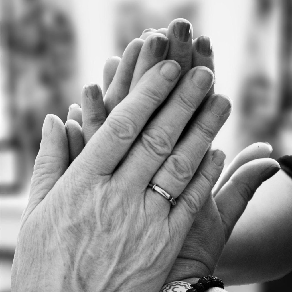 hands praying black and white photo