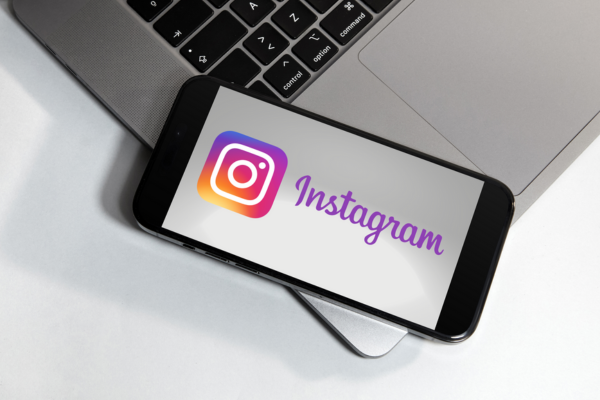 iPhone der ligger på mac med instagram-logo